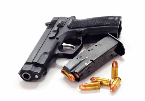 A gun and bullets on a white background.